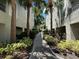 Community walkway surrounded by lush greenery and residential buildings at 622 Seascape Way, Tampa, FL 33602