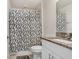 Bathroom with granite counters and a shower with a decorative curtain at 6384 Ten Acre Ct, Zephyrhills, FL 33541