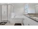 Bathroom featuring a glass shower, tub and a granite countertop sink at 6384 Ten Acre Ct, Zephyrhills, FL 33541