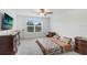 Well-lit bedroom featuring a cozy bed, dresser, and large window at 6384 Ten Acre Ct, Zephyrhills, FL 33541