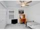 Well-lit bedroom with a fan, desk, bed, and closet at 6384 Ten Acre Ct, Zephyrhills, FL 33541