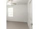 Bright bedroom with a fan, window, and closet at 6384 Ten Acre Ct, Zephyrhills, FL 33541
