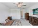Bedroom featuring a bed, dresser, closet, and TV at 6384 Ten Acre Ct, Zephyrhills, FL 33541