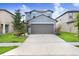 Charming two-story home featuring a well-maintained lawn and attached two car garage at 6384 Ten Acre Ct, Zephyrhills, FL 33541
