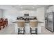 Modern kitchen featuring granite countertops, stainless steel appliances, and white cabinets at 6384 Ten Acre Ct, Zephyrhills, FL 33541