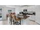 Modern kitchen featuring granite countertops, stainless steel appliances, and white cabinets at 6384 Ten Acre Ct, Zephyrhills, FL 33541