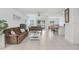 Open concept living room and dining area with tile floors, bright lighting, and neutral paint at 6384 Ten Acre Ct, Zephyrhills, FL 33541