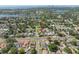 Sweeping aerial view of a suburban neighborhood with mature trees and city skyline in the distance at 656 40Th Ne Ave, St Petersburg, FL 33703
