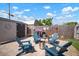 Cozy backyard features a brick-paved seating area with Adirondack chairs, a fire pit, and a storage shed at 656 40Th Ne Ave, St Petersburg, FL 33703