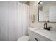 Bathroom featuring a white vanity, black faucet, and tiled shower at 656 40Th Ne Ave, St Petersburg, FL 33703