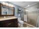 Bathroom with a glass shower, tiled walls, and a dark wood vanity at 656 40Th Ne Ave, St Petersburg, FL 33703