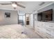 Bedroom with gray walls, modern ceiling fan, and ensuite bathroom access at 656 40Th Ne Ave, St Petersburg, FL 33703
