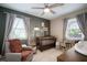 Cozy Bedroom with a crib, chair, soft lighting, and two large windows at 656 40Th Ne Ave, St Petersburg, FL 33703