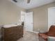 Bedroom with wood floors, dresser, comfortable chair, and a neutral color scheme at 656 40Th Ne Ave, St Petersburg, FL 33703