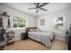 Neutral bedroom with natural light, a ceiling fan, and wood-look flooring at 656 40Th Ne Ave, St Petersburg, FL 33703