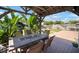A covered patio with table and chairs surrounded by tropical landscaping at 656 40Th Ne Ave, St Petersburg, FL 33703