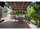 Covered patio with seating area, wood flooring, and beautiful hanging plants at 656 40Th Ne Ave, St Petersburg, FL 33703