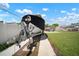 Spacious driveway leading to a boat parked in the backyard with a well-maintained lawn and brick pathway at 656 40Th Ne Ave, St Petersburg, FL 33703