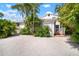 Charming white home featuring lush landscaping and a quaint picket fence at 656 40Th Ne Ave, St Petersburg, FL 33703