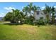 Green lawn with palm trees and greenery, complementing the exterior of the home at 656 40Th Ne Ave, St Petersburg, FL 33703