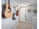 Upstairs hallway features guitars, floating shelves, and vinyl floors at 656 40Th Ne Ave, St Petersburg, FL 33703