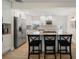 Bright kitchen with white cabinets, granite countertops, and stainless steel appliances, island with seating at 656 40Th Ne Ave, St Petersburg, FL 33703