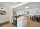 Bright kitchen featuring a center island with seating, modern appliances, and seamlessly flowing layout at 656 40Th Ne Ave, St Petersburg, FL 33703