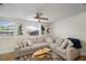 Comfortable living room with a cozy couch, leafy artwork, and natural light at 656 40Th Ne Ave, St Petersburg, FL 33703