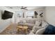 Bright living room features a ceiling fan, L-shaped couch, and large windows at 656 40Th Ne Ave, St Petersburg, FL 33703