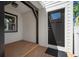 Inviting front porch with stylish black door, modern lighting, complemented by a beautiful window at 656 40Th Ne Ave, St Petersburg, FL 33703