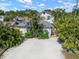 A bright white house with a gray roof, with palm trees surrounding the property at 656 40Th Ne Ave, St Petersburg, FL 33703