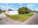 Grassy side yard enclosed with a white fence offering space and privacy at 656 40Th Ne Ave, St Petersburg, FL 33703