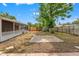 Spacious backyard featuring a patio area, mature trees, and a wooden fence for privacy at 6982 78Th N Ave, Pinellas Park, FL 33781