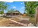 Landscaped backyard featuring a screen porch and stepping stones, offering a serene outdoor space for relaxation at 6982 78Th N Ave, Pinellas Park, FL 33781