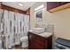 This bathroom features a unique stone tile backsplash, a white vessel sink, and wood beam accents at 6982 78Th N Ave, Pinellas Park, FL 33781