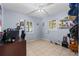 Spacious blue bedroom with a desk area and two windows bringing in natural light at 6982 78Th N Ave, Pinellas Park, FL 33781