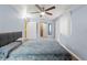 Comfortable bedroom featuring cool-toned walls, laminate floors, and a ceiling fan at 6982 78Th N Ave, Pinellas Park, FL 33781