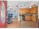 Bright, open-concept layout showcasing a well-equipped kitchen with wooden cabinets, tile flooring, and stainless steel appliances at 6982 78Th N Ave, Pinellas Park, FL 33781