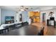 Spacious living room with hardwood flooring, ceiling fan, large table, and view into a kitchen at 6982 78Th N Ave, Pinellas Park, FL 33781