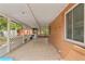 Large covered patio with screening and tile flooring, perfect for entertaining at 6982 78Th N Ave, Pinellas Park, FL 33781