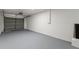 Spacious garage features smooth concrete floor and roll up door, great for parking and storage at 7400 Belvedere Ter, New Port Richey, FL 34655