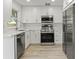 Stylish kitchen with stainless steel appliances, white cabinets, and modern countertops at 7400 Belvedere Ter, New Port Richey, FL 34655
