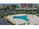 Unique shaped community pool with plenty of seating and palm trees at 7700 Sun Island S Dr # 105, South Pasadena, FL 33707
