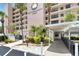 Inviting entrance with covered walkway and lush greenery enhances the exterior of The Commodore 7700 building at 7700 Sun Island S Dr # 105, South Pasadena, FL 33707