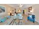Open floor plan living and dining area with tile floors, comfortable seating, and ceiling fan at 7700 Sun Island S Dr # 105, South Pasadena, FL 33707
