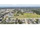 Aerial view of a residential area with parks, fields, and proximity to the coastline in the distance at 8956 124Th Way, Seminole, FL 33772