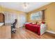 Bedroom with hardwood floors, a daybed and a large window that provides ample natural light at 8956 124Th Way, Seminole, FL 33772
