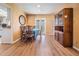 Cozy dining room features wood floors, a round mirror and light from the french doors at 8956 124Th Way, Seminole, FL 33772