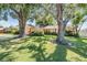 Quaint home with mature trees shading the front yard, offering a serene and inviting curb appeal at 8956 124Th Way, Seminole, FL 33772