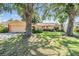 Charming single-story home with a well-maintained lawn and mature trees at 8956 124Th Way, Seminole, FL 33772